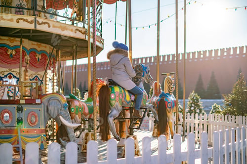 Preview: photo of colorful carousel with children in warm sunny spring day b