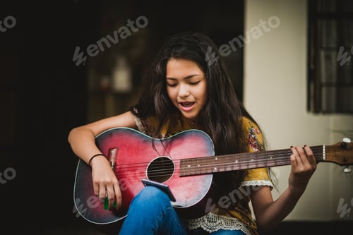 Preview: Teenage Girl Plays Guitar and Reads Lyrics