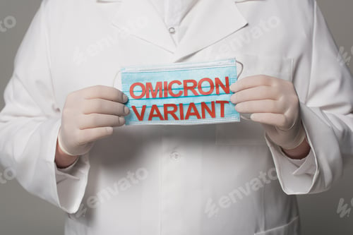 Preview: Cropped view of doctor in latex gloves holding medical mask with omicron variant lettering on grey