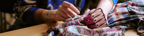 Preview: Unrecognizable Woman Using Prosthetic Hand Repairing Second Hand Clothing