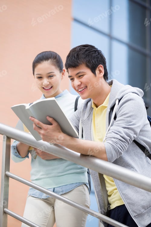 Preview: Young couple reading outside library