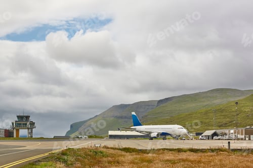 Preview: Faroe islands airport runway and control tower with airplane.