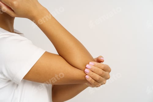 Preview: African woman suffer from pain in elbow massaging hand. Female with hurting arm or bone fracture