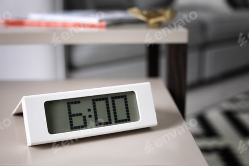 Preview: Digital alarm clock on table in living room. Time of day