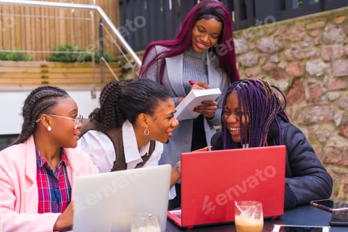 Preview: Young businesswomen of black ethnicity. In a business meeting in a cafeteria