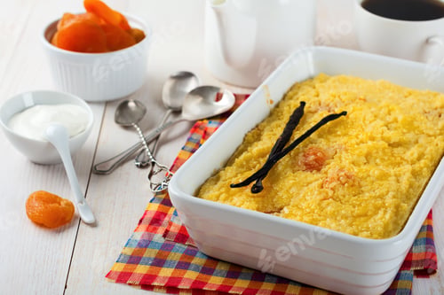 Preview: Millet pudding with dried apricots for breakfast on a light background. Selective focus