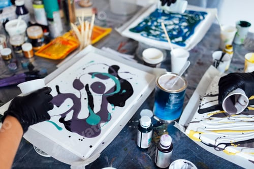 Preview: Master class on an Acrylic Fluid Pouring. Young women paint with liquid acrylic in an art workshop