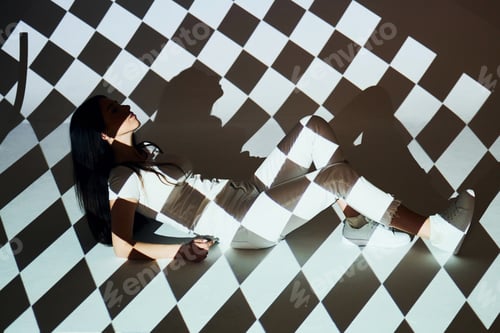 Preview: Square shaped lights. Beautiful young woman is in projector in the studio