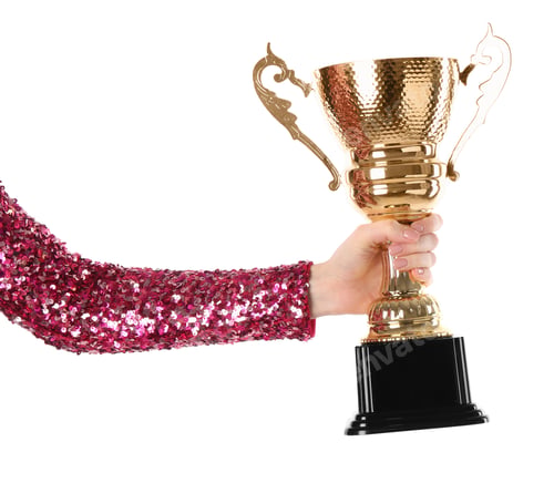 Preview: Woman with golden trophy cup on white background, closeup