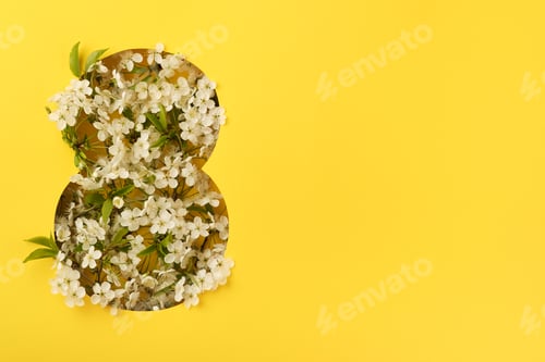 Preview: 8 March greeting card. Paper cut Eight made of yellow background and fresh spring flowers bouquet of