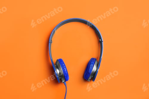 Preview: Stylish headphones on color background, top view