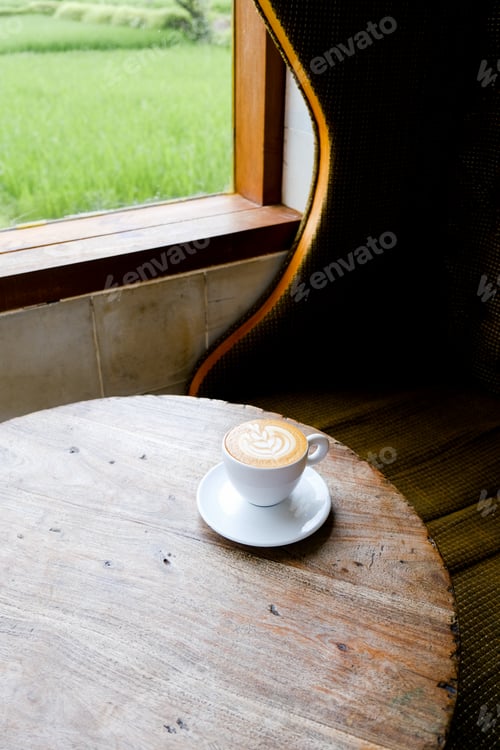 Preview: white cup of cappuccino on wooden background with beautiful latte art