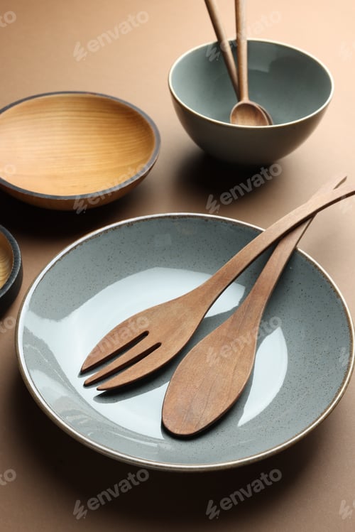 Preview: Stylish empty dishware and wooden cutlery on brown background
