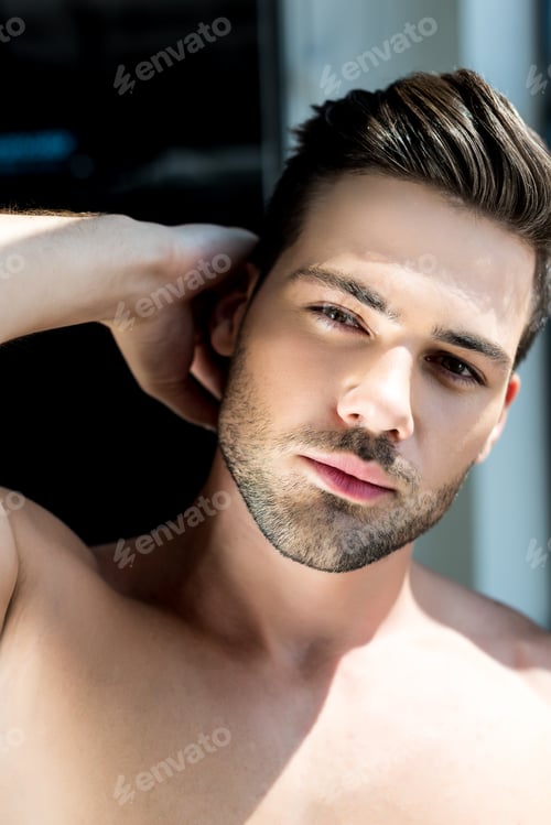 Preview: handsome shirtless young man looking at camera