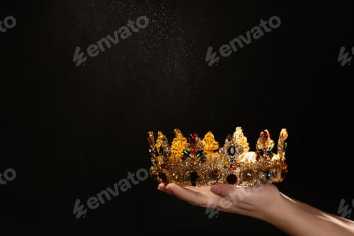 Preview: Woman holding beautiful golden crown on black background, closeup with space for text. Fantasy item