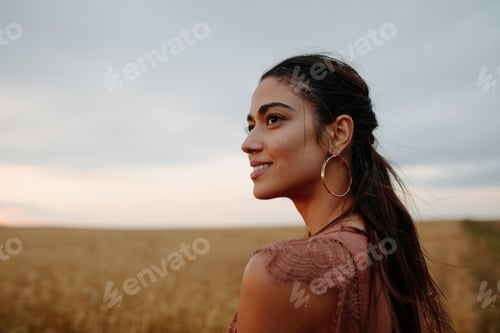 Preview: Young Woman Outdoors in Golden Field at Sunset