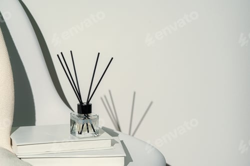Preview: Liquid home perfume in glass diffuser with sticks on chair