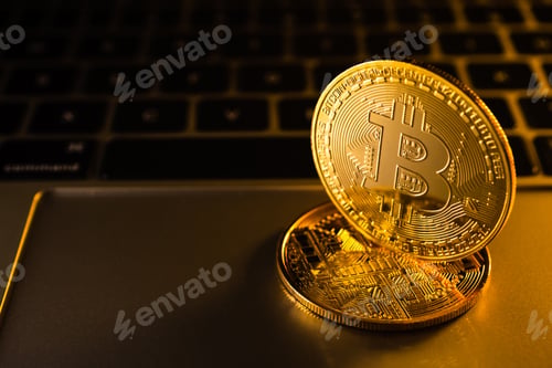 Preview: Golden coins with bitcoin symbol on computer.