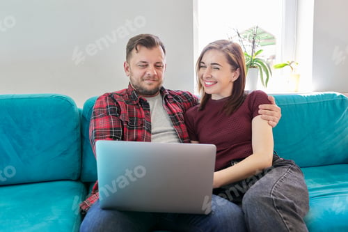 Preview: Couple Relaxing on Couch Using Laptop Together