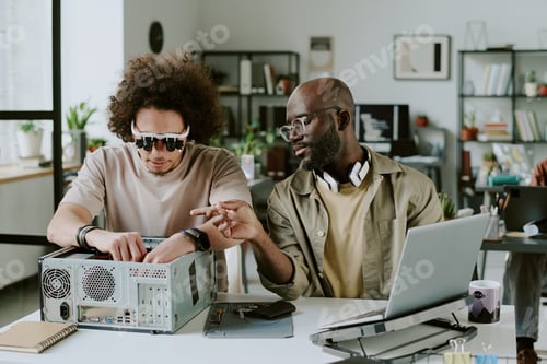 Preview: Man Helping Friend with Computer