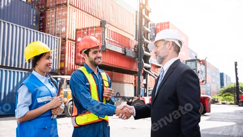 Preview: Engineer and foreman shake hand at container yard near with a forklift.
