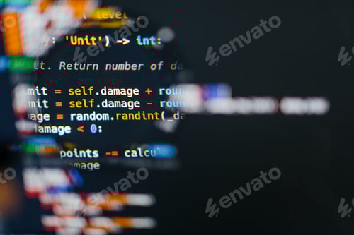 Preview: Program code on computer display in magnifying glass. Close-up
