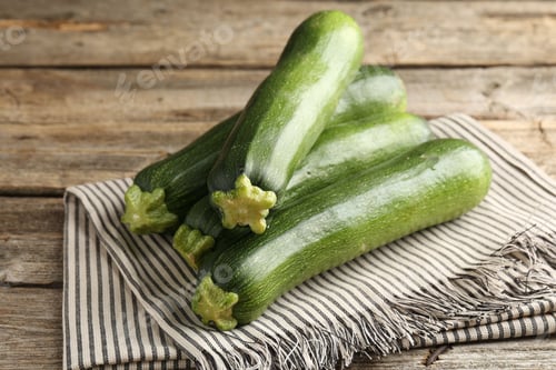 Preview: Fresh ripe zucchinis on wooden table, closeup