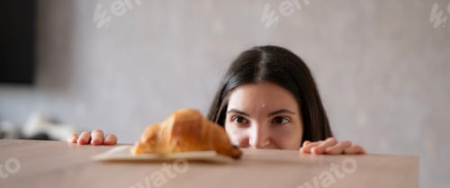 Preview: A girl crouches under the table, eagerly looking for a yummy croissant
