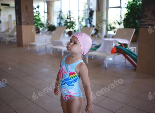 Preview: little cute girl working out on land by the pool