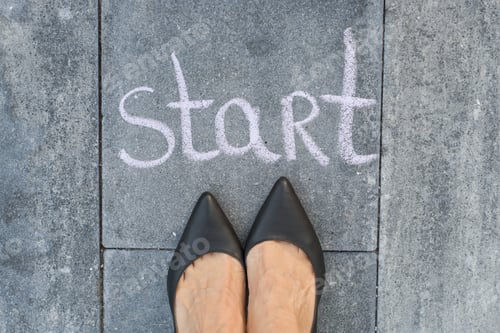 Preview: Businesswoman feet are facing the word "start"