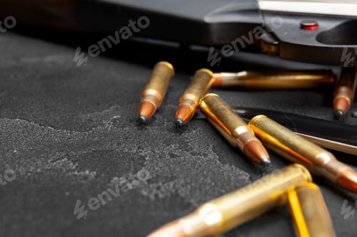 Preview: Close up of hunting shotgun and cartridges on dark grey background