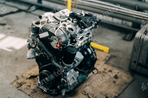 Preview: An internal combustion engine removed from a vehicle for repair. Replacing the engine at a service