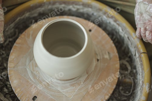 Preview: Woman making pottery on the spinning wheel