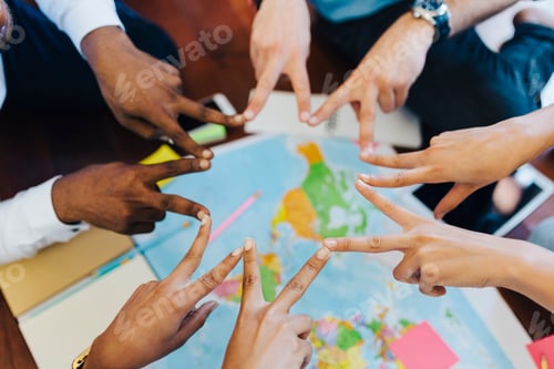 Preview: Group of friends making hand sign above world map