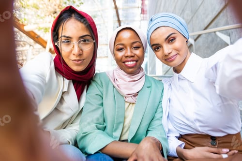 Preview: Beautiful muslim girl wearing hijab bonding outdoors