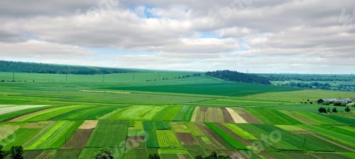 Preview: Panoramic view from above on agricultural patch of land, fields and gardens