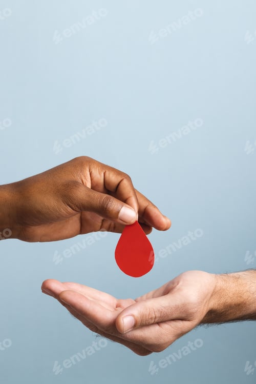 Preview: Hands of biracial man giving blood drop to caucasian man, on blue background with copy space