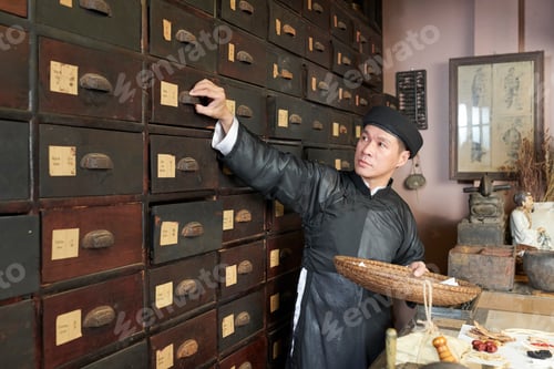 Preview: Man taking out dry herbs and mushrooms