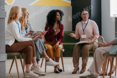 Preview: Confident mature women communicating while visiting group training class