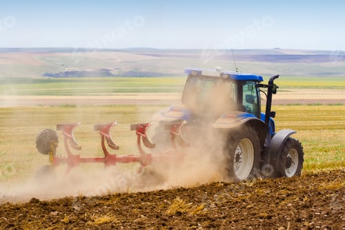 Preview: tractor ploughing a field with trail of dust