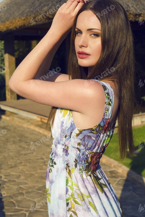 Preview: Portrait Of Beautiful Woman With Dark Hair And Blue Eyes Posing At Summer Garden