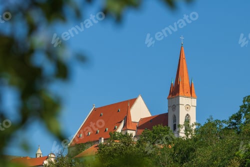 Preview: Church with red roof against blue sky