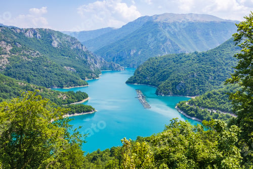 Preview: Aerial view of Piva lake or Pivsko Jezero between hills covered with green trees