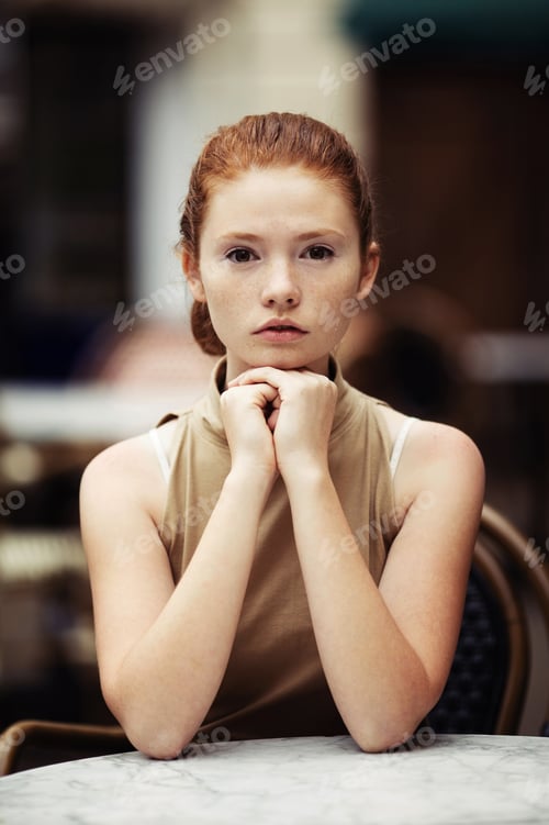 Preview: beautiful girl waiting at a table in a cafe
