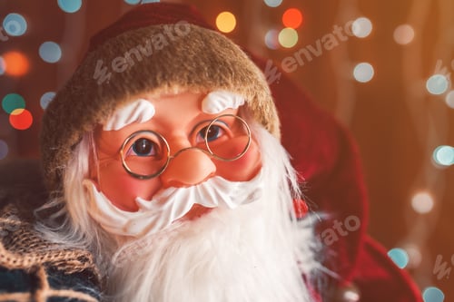 Preview: Santa Claus dummy toy with festive colorful string light bokeh background