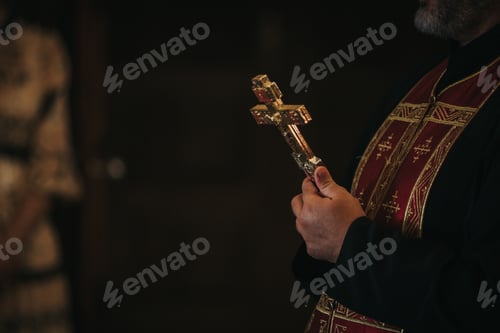 Preview: Closeup shot of the priest holding the cross during the wedding ceremo