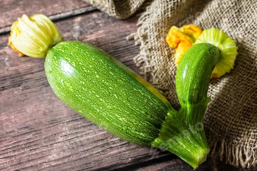 Preview: Fresh vegetable. Ugly organic twisted zucchini on wooden table.