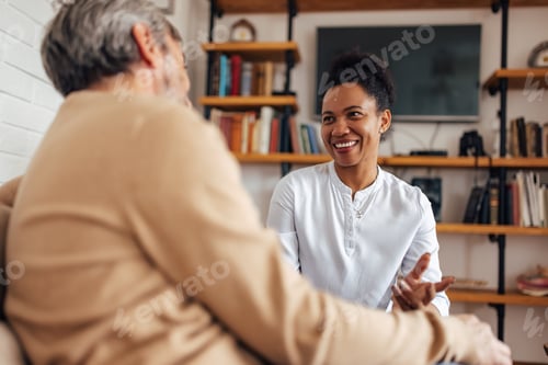 Preview: Happy couple, relaxing at home, talking to each other.
