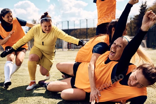 Preview: Female soccer team celebrating after the match on a stadium.