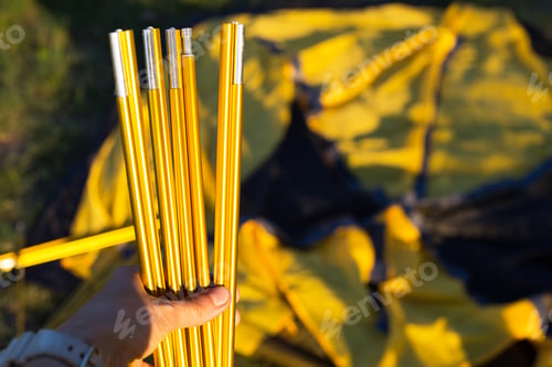 Preview: Aluminum mounting arcs for the installation of a tourist yellow tent in the hand close-up